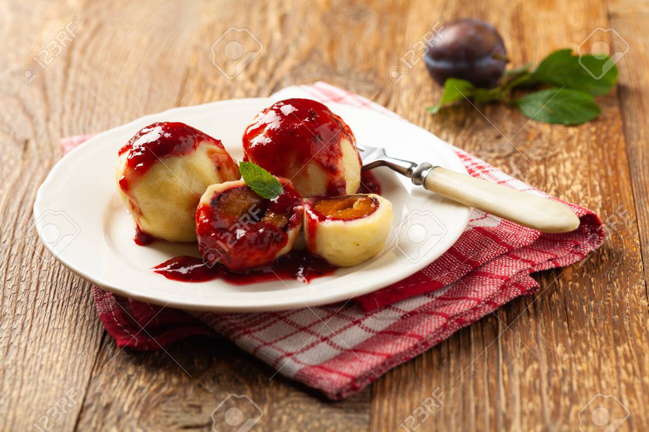 dumplings with plums topped with cream