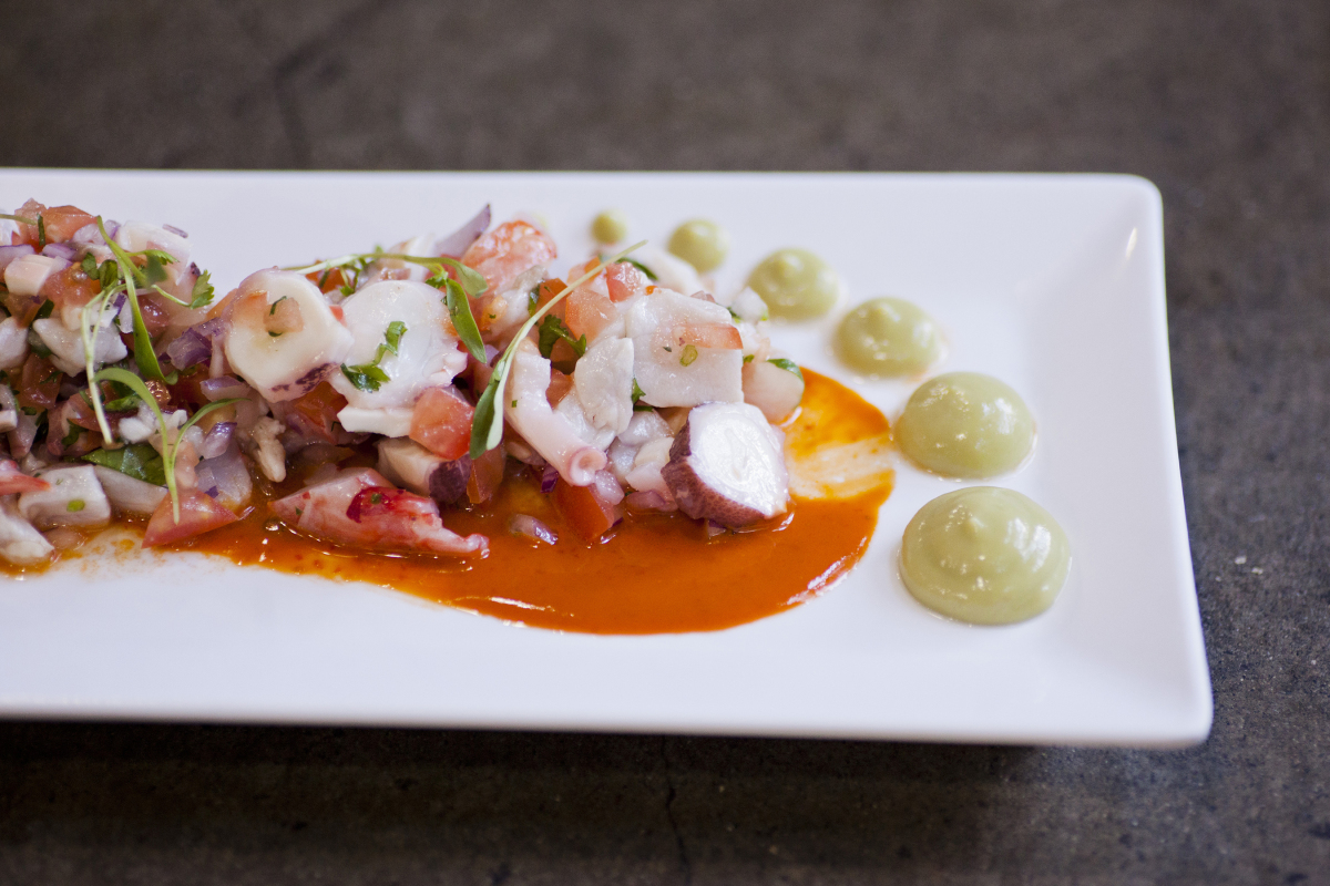 avocado spread served with octopus pieces