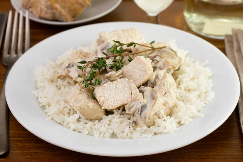 chicken breast on cream with rice