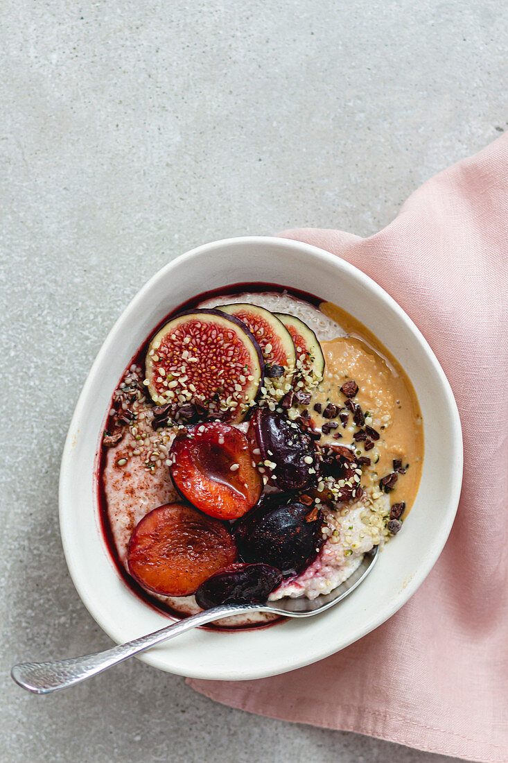 buckwheat oat porridge with cashew nuts and plums