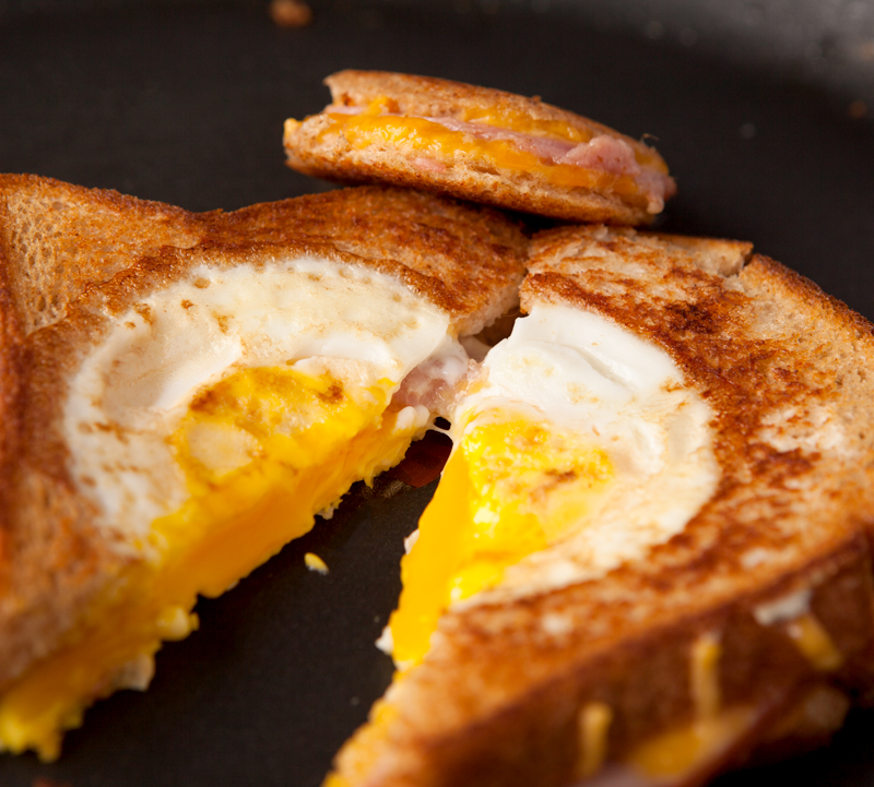 eggs baked in toast with ham and cheese