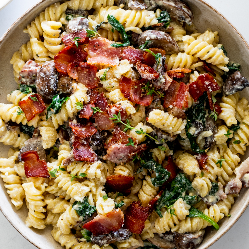 recipe of cherry tomatoes chicken pasta with a block of feta cheese