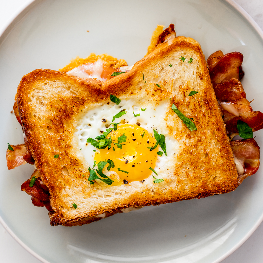 slice of bread smeared with butter topped with an egg