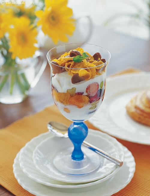 snack in a glass yoghurt with flakes and fruit