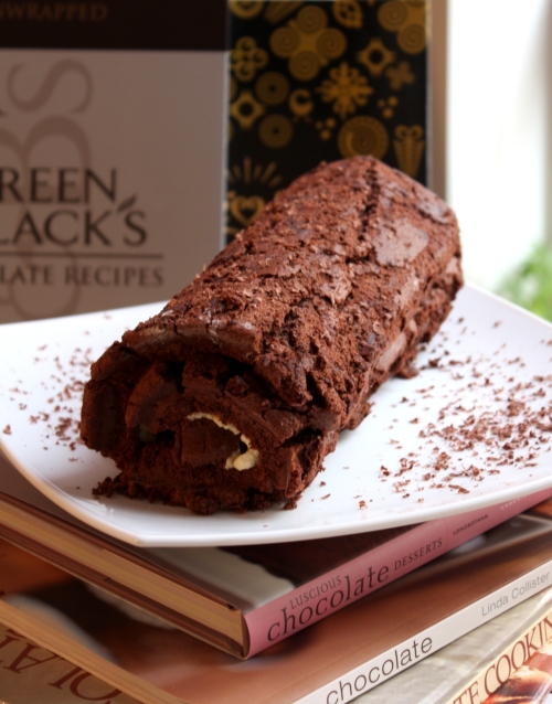 snowy chocolate roulade with currant jam and whipped cream